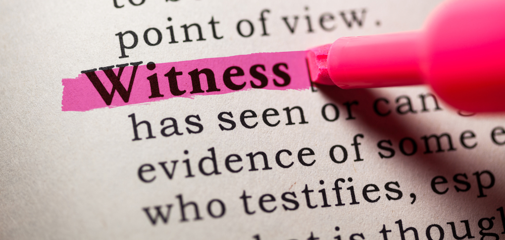 An image of the word witness being highlighted in a dictionary